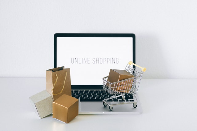 an image showing laptop and cart to signify e-commerce shopping