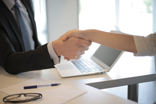 two peoples shaking hands each other