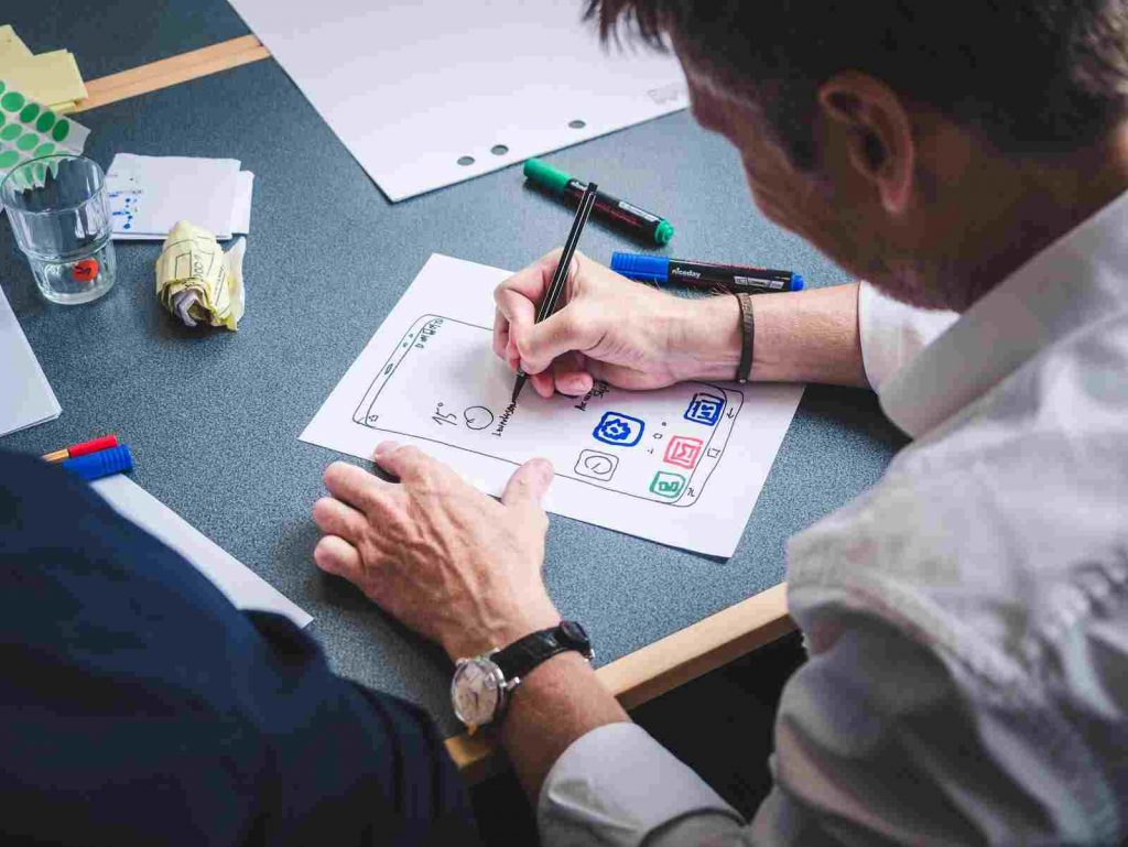 a man prototyping a design of mobile app